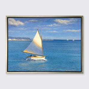 A blue, beige and white realist seascape print with a sailboat in a silver floater frame hangs on a white wall.