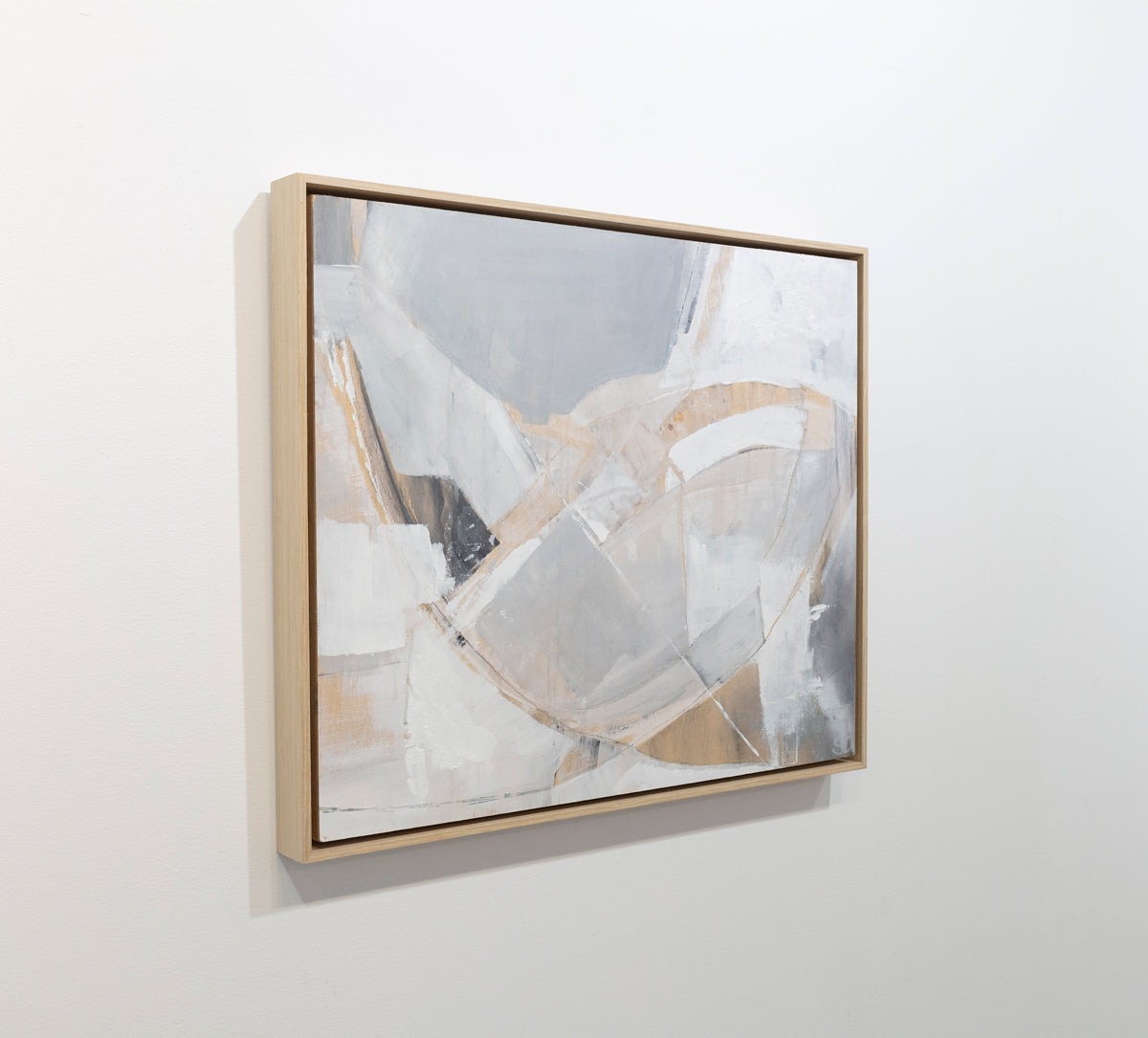 An abstract painting with white, orange and grey patches is seen at an angle on a gallery wall. Wired and ready to hang.