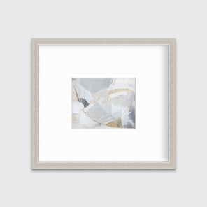 A light grey, beige and white abstract print in a silver frame with a mat hangs on a white wall.