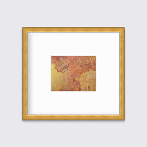 A gold, purple and white abstract print in a gold frame with a mat hangs on a white wall.