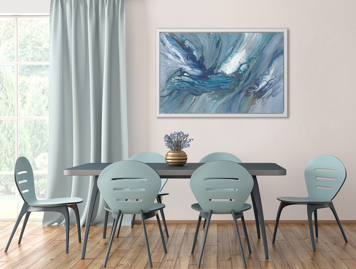 A blue, teal and white abstract print in a white floater frame hangs on white wall above a dark teal table and six teal chairs.