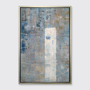 A blue, silver, white and grey abstract geometric print in a silver floater frame hangs on a white wall.