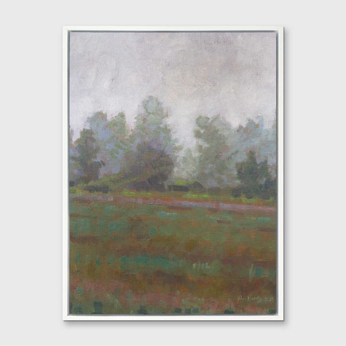 A grey and muted green abstract landscape print in a white floater frame hangs on a white wall.