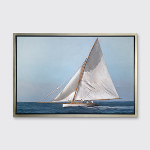 A blue, white and tan contemporary seascape print with a sailboat in a silver floater frame hangs on a white wall.