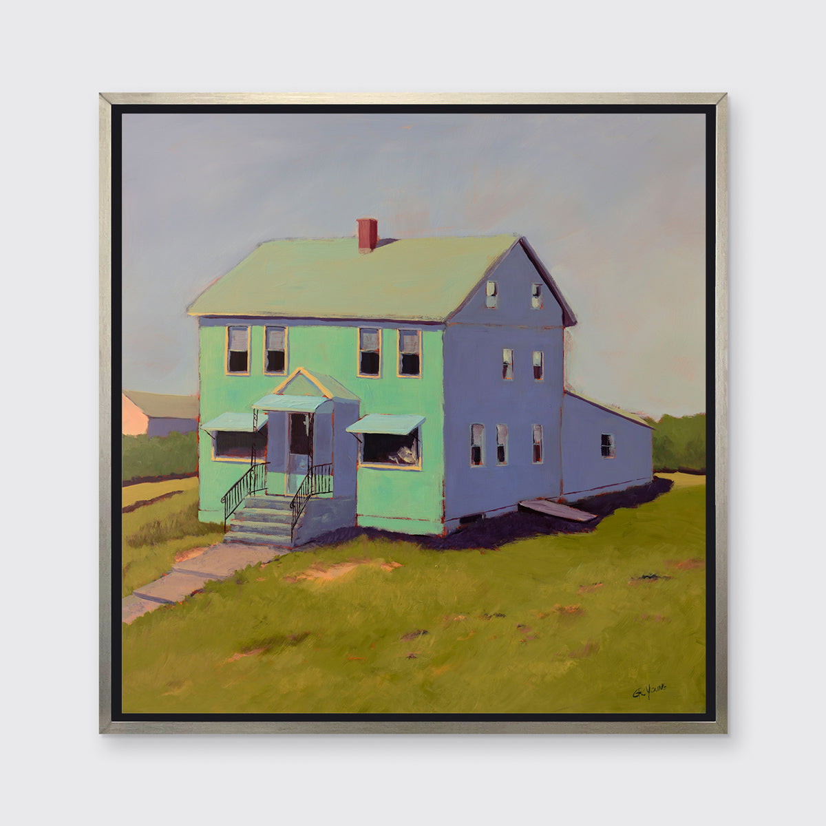 A seafoam green, blue and chartruse contemporary house print in a silver floater frame hangs on a white wall.