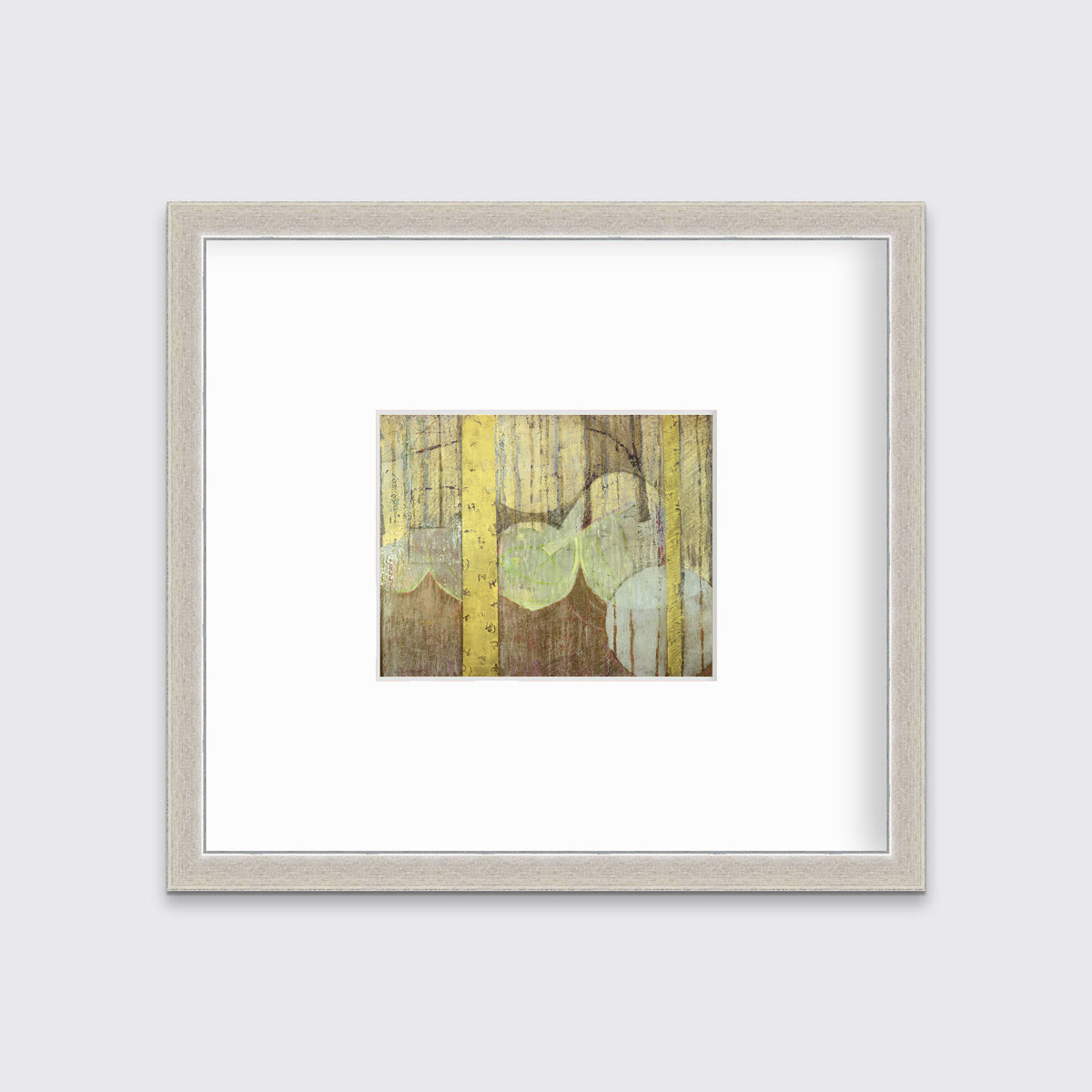 A gold, yellow, light green and light blue abstract in a silver frame with a mat hangs on a white wall.