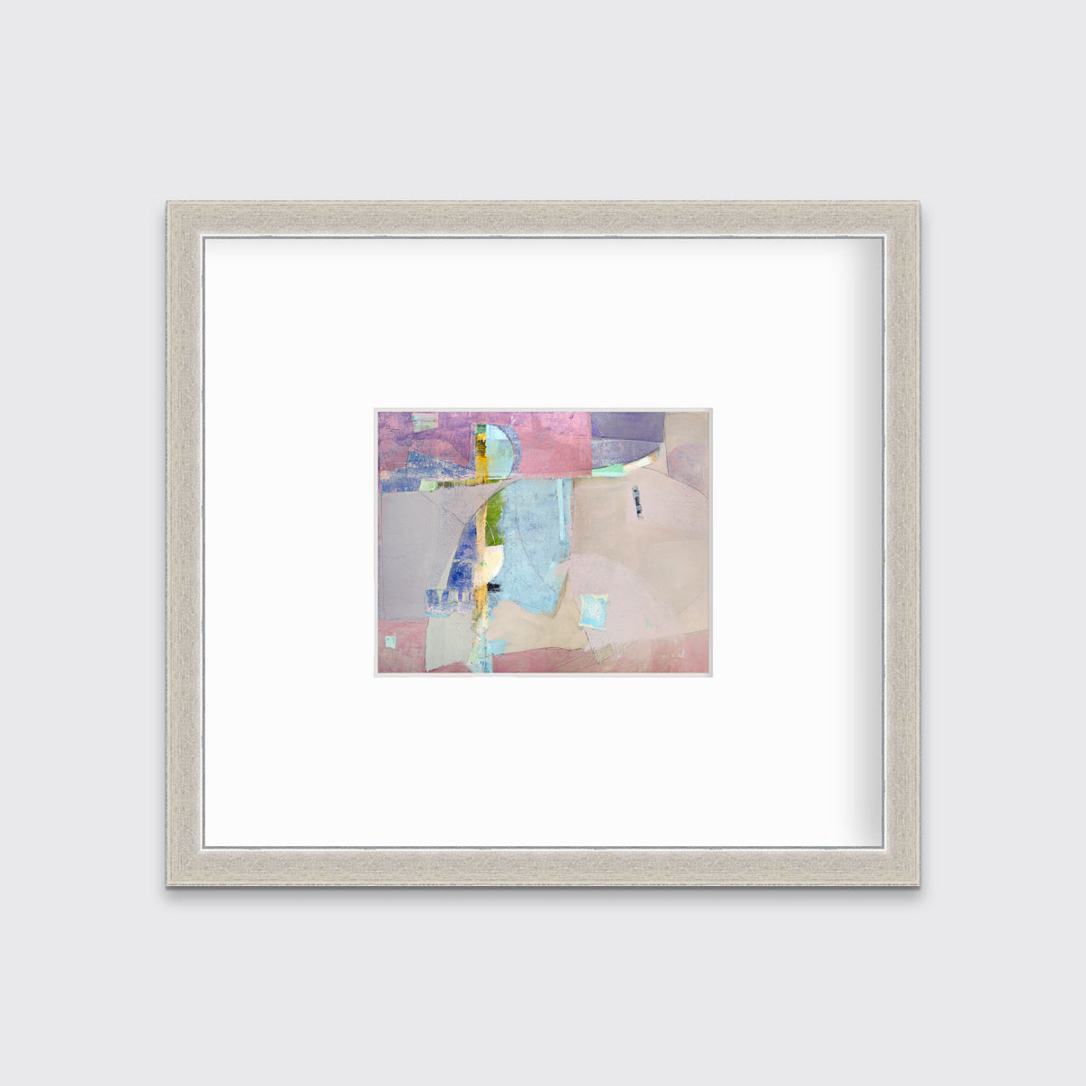 A pink, light blue, green and purple abstract print in a silver frame with a mat hangs on a white wall.