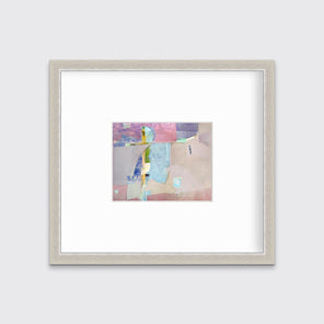 A pink, light blue, green and purple abstract print in a silver frame with a mat hangs on a white wall.