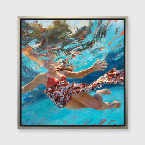 A colorful distorted figurative print of a girl underwater in a silver floater frame hangs on a white wall.