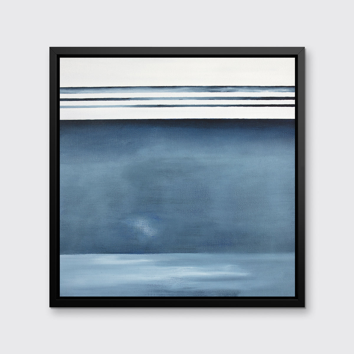 A blue and white abstract print in a black floater frame hangs on a white wall.