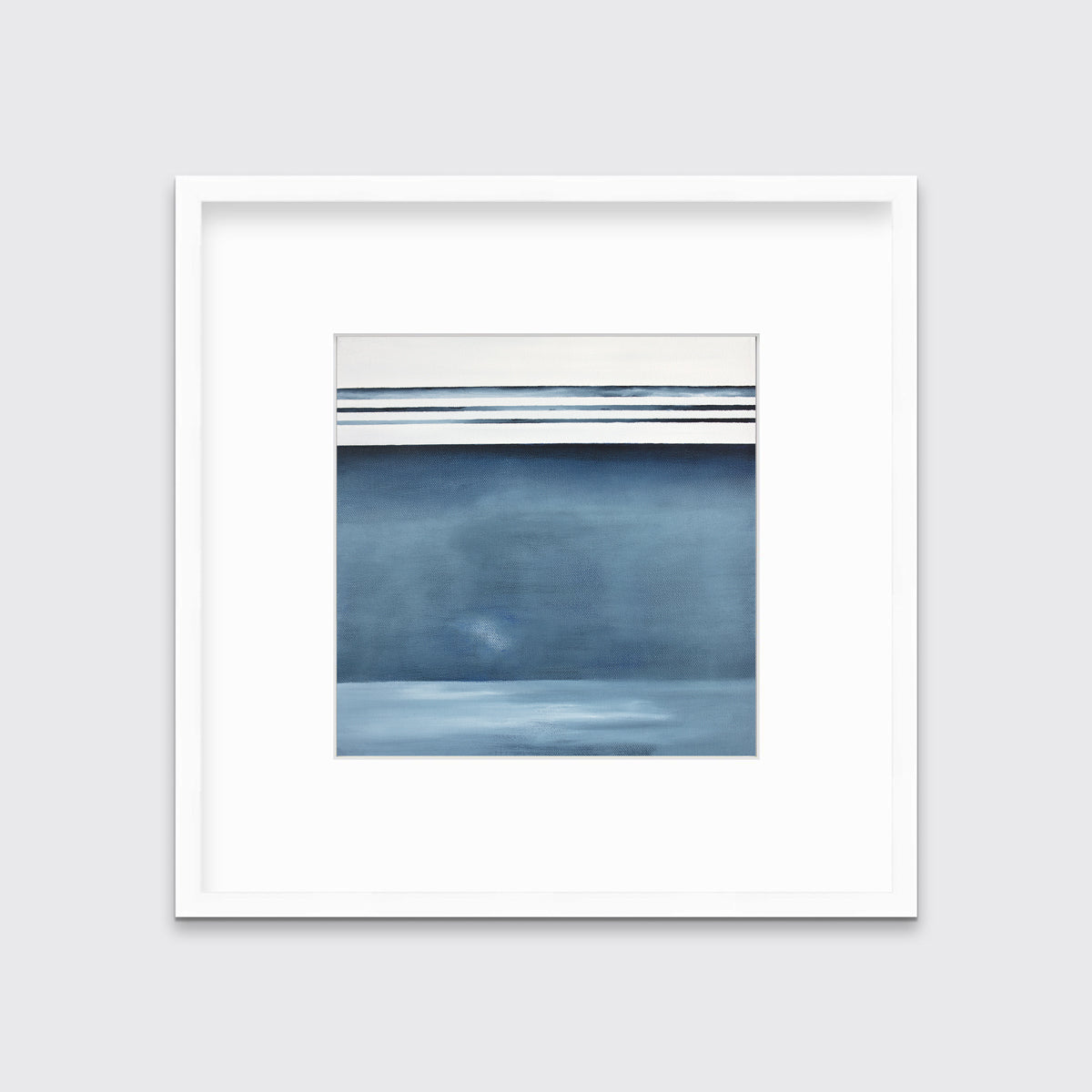 A blue and white abstract linear landscape print in a white frame with a mat hangs on a white wall.
