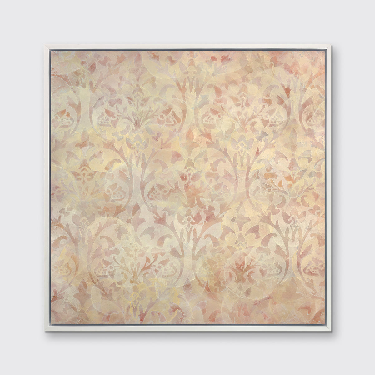 A pale pink and pale yellow abstract print in a white floater frame hangs on a white wall.