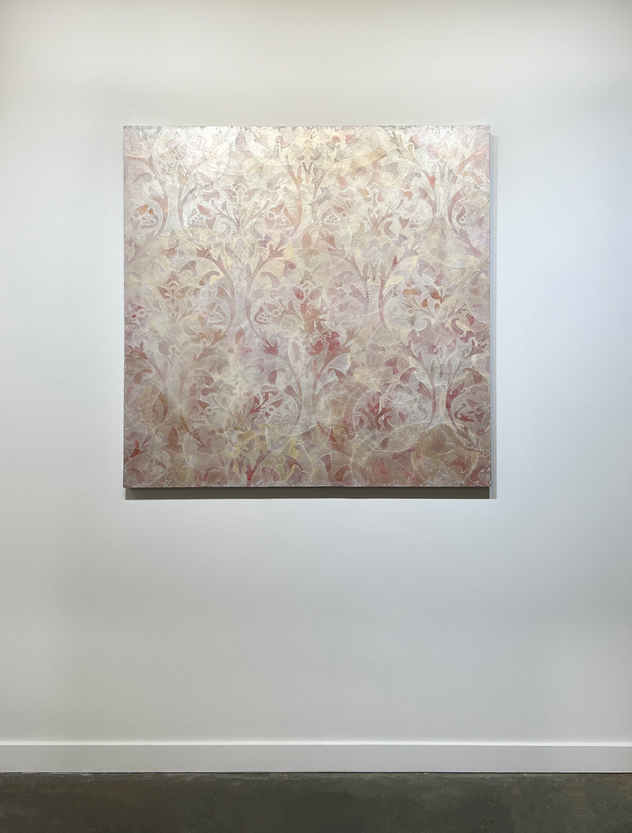 A coral, beige and gold-leaf abstract painting by Roger Mudre hangs on a white wall.