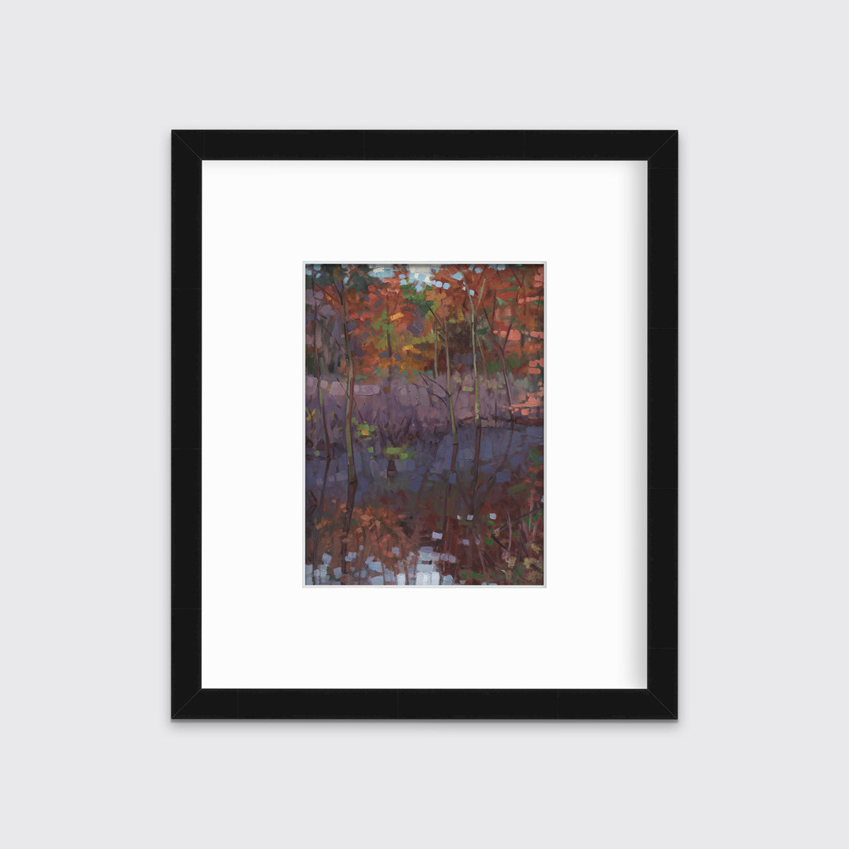 A muted multicolored abstract landscape print in a black frame with a mat hangs on a white wall.