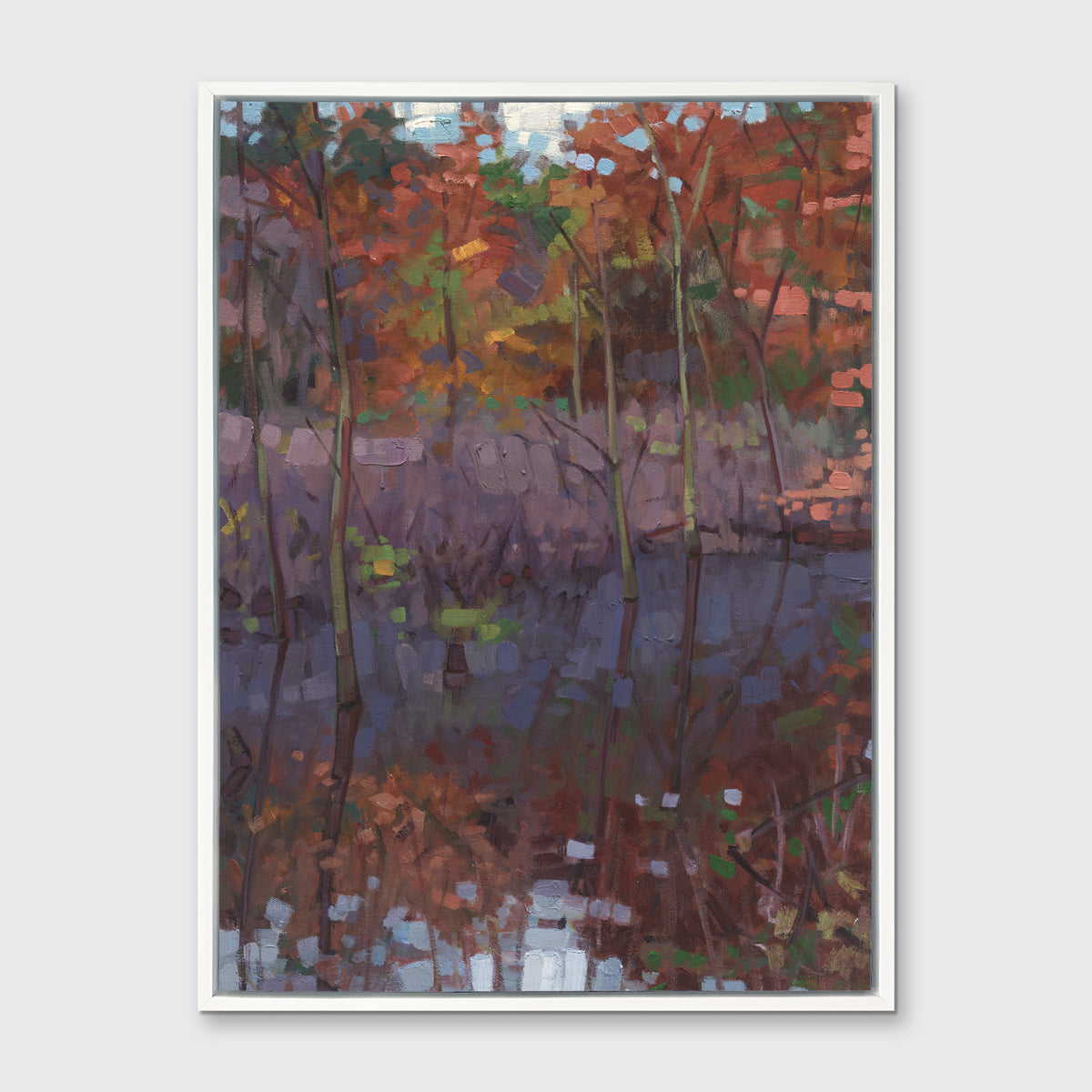 A muted multicolored abstract landscape print in a white floater frame hangs on a white wall.