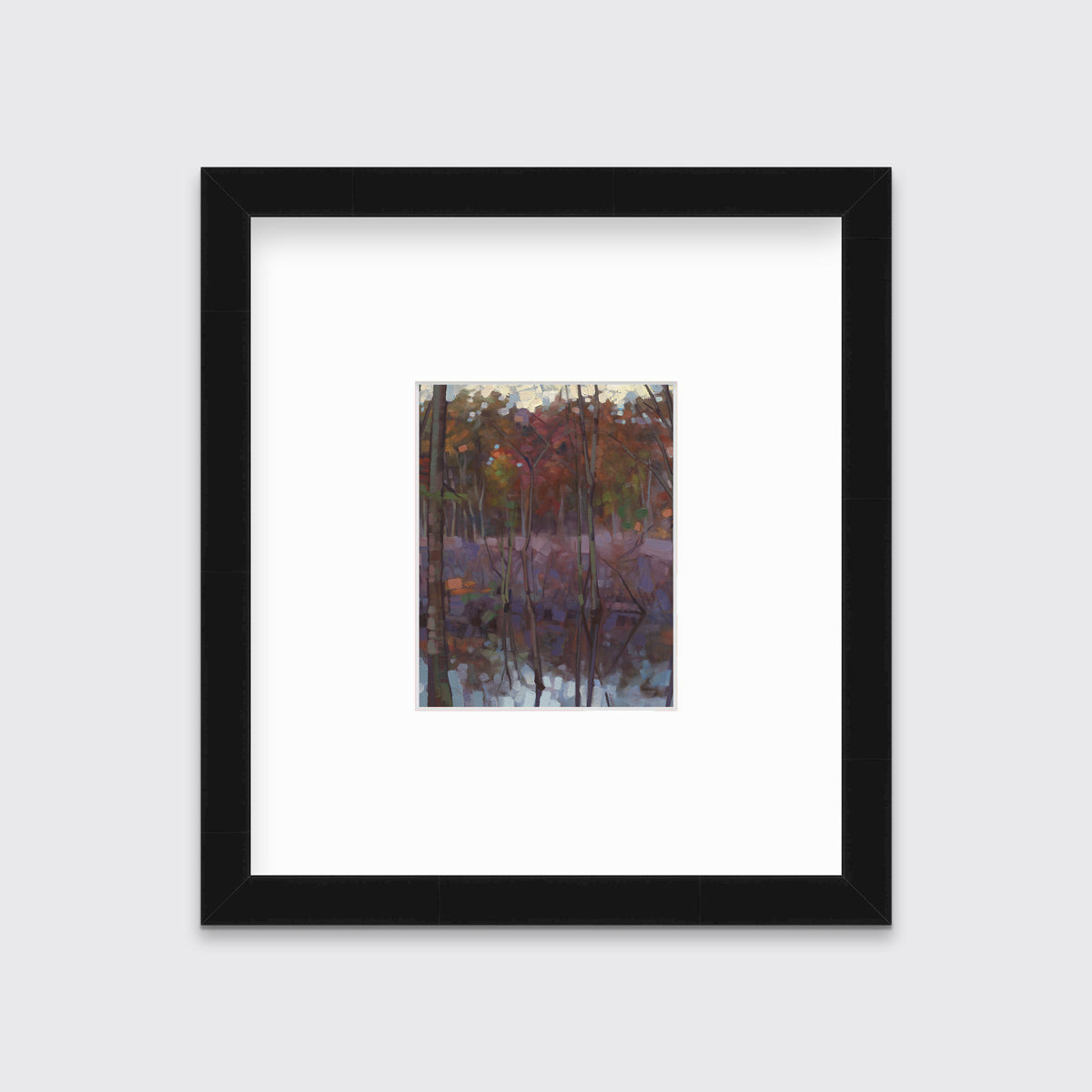A muted multicolored abstract landscape print in a black frame with a mat hangs on a white wall.
