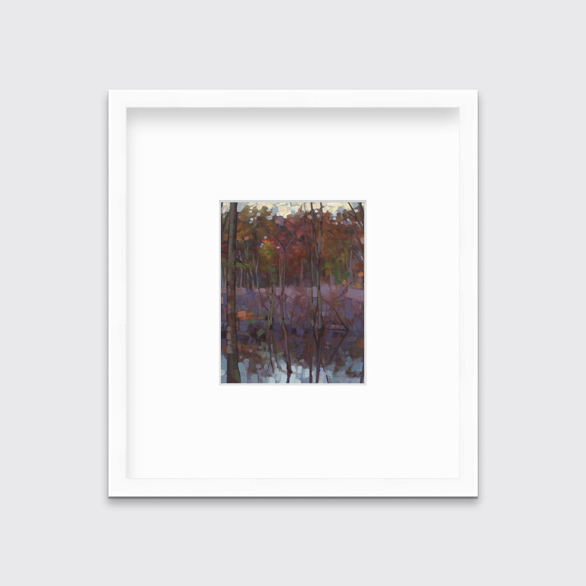 A muted multicolored abstract landscape print in a white frame with a mat hangs on a white wall.