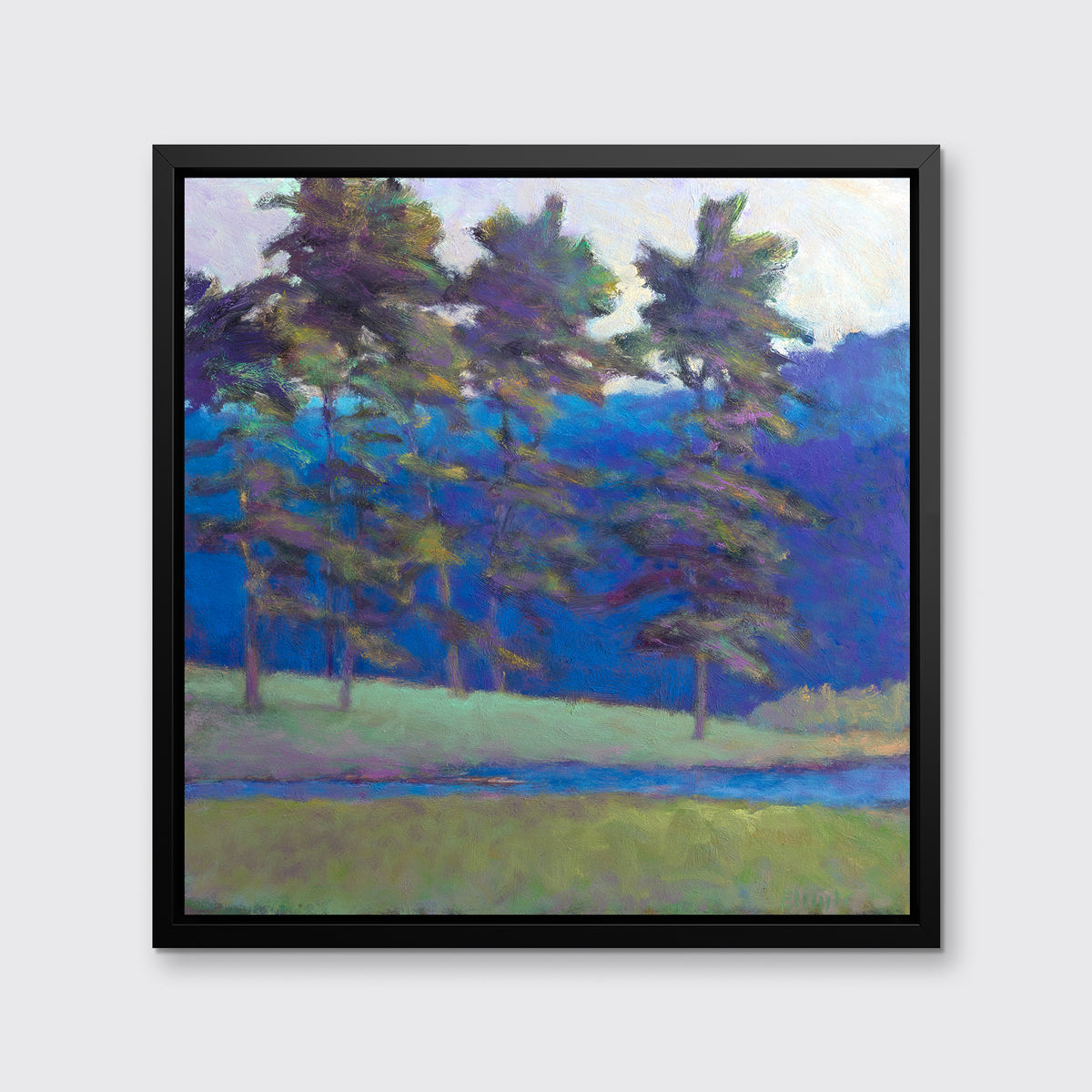 A blue and green abstract tree landscape print in a black floater frame hangs on a white wall.