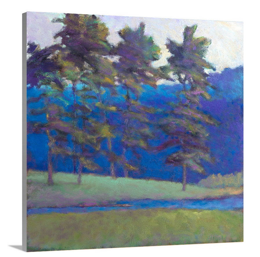A side-angle view of a blue and green tree landscape print on canvas.