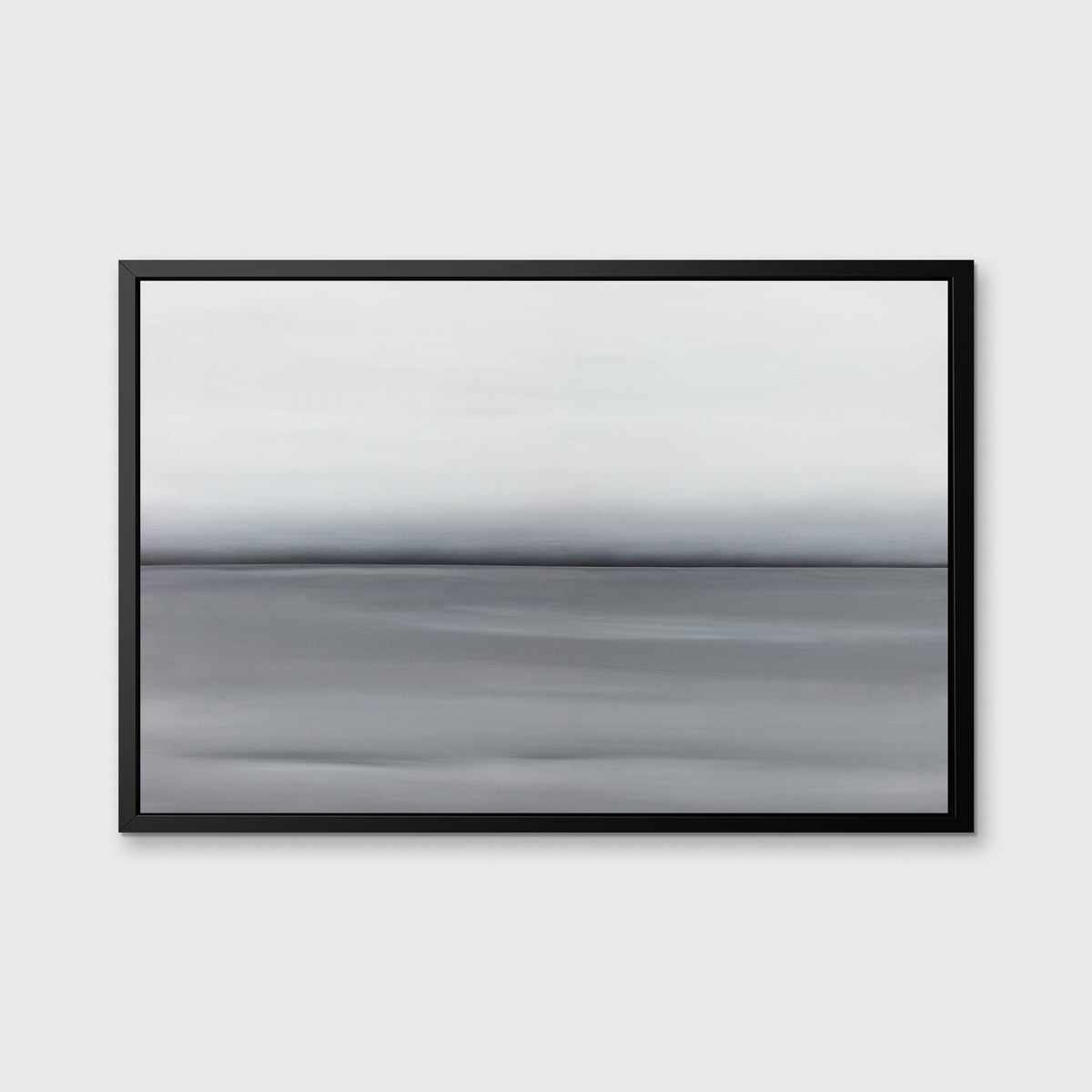 A grey toned abstract landscape print in a black floater frame hangs on a white wall.