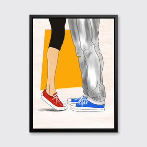 Art print with man and woman wearing Converse sneakers, framed in a black floater frame and hanging on a grey wall.