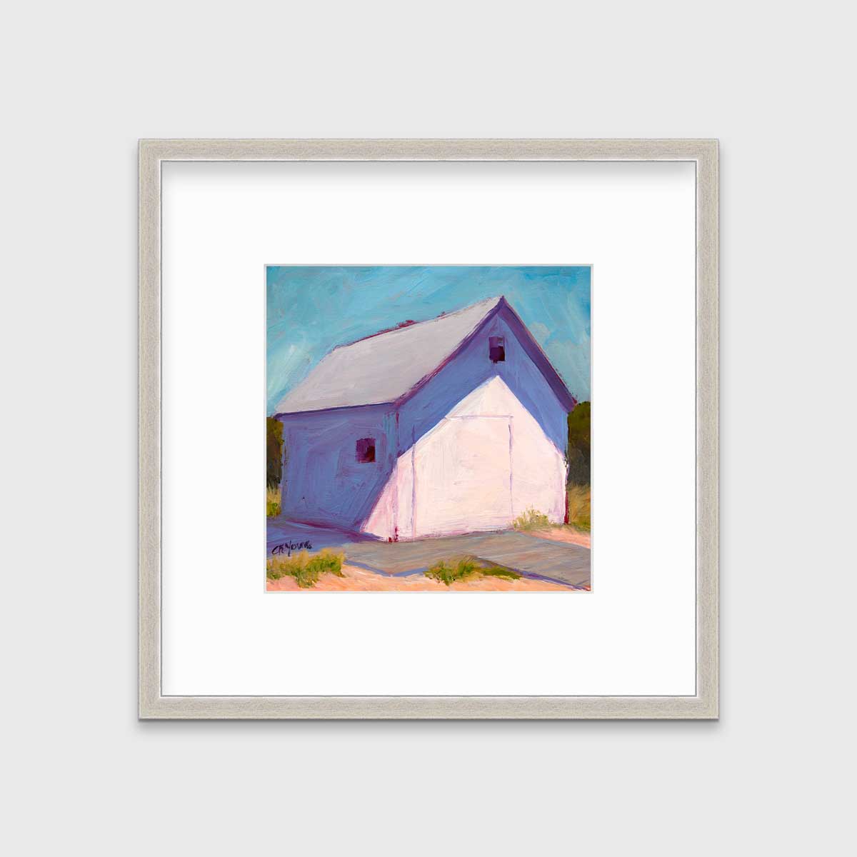 A blue, white and lavender contemporary barn print in a silver frame with a mat hangs on a white wall.