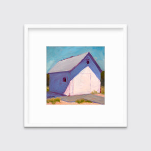A blue, white and lavender contemporary barn print in a white frame with a mat hangs on a white wall.