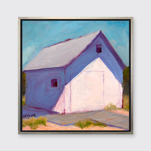 A blue, white and lavender contemporary barn print in a silver floater frame hangs on a white wall.