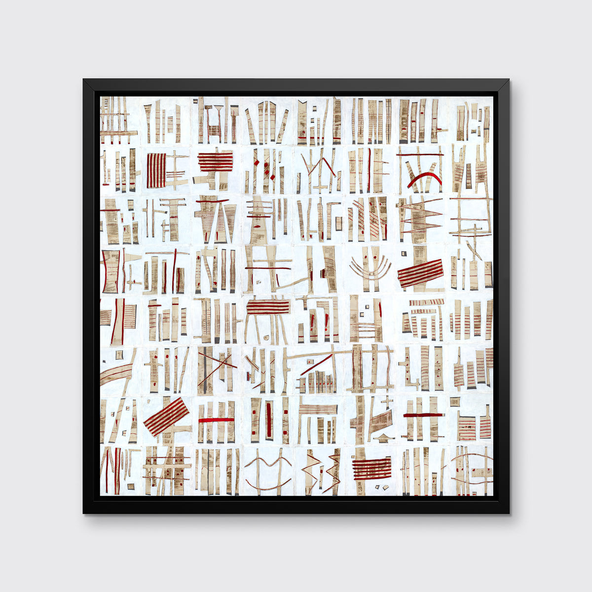 A white, beige and red abstract print in a black floater frame hangs on a white wall.