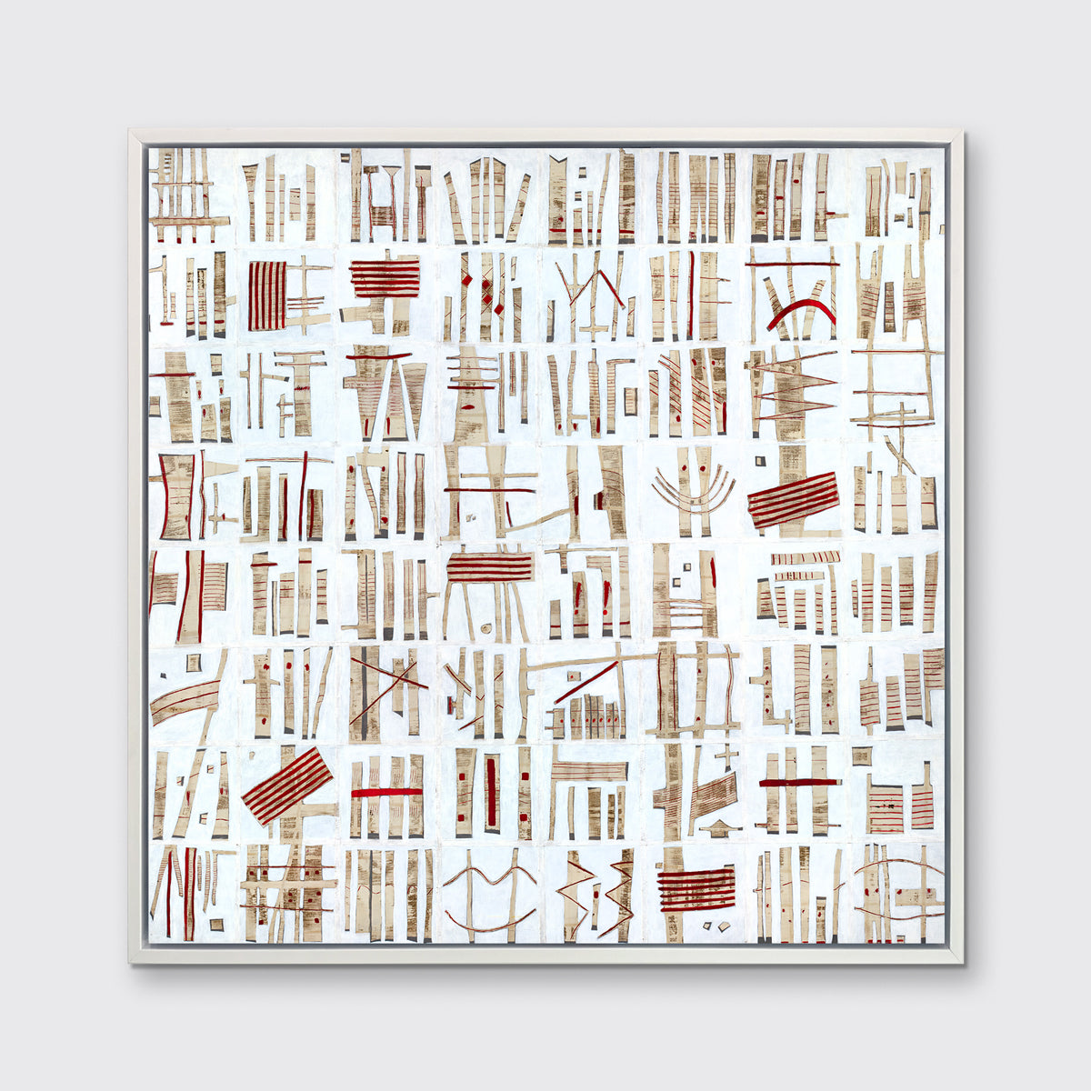 A white, beige and red abstract print in a white floater frame hangs on a white wall.