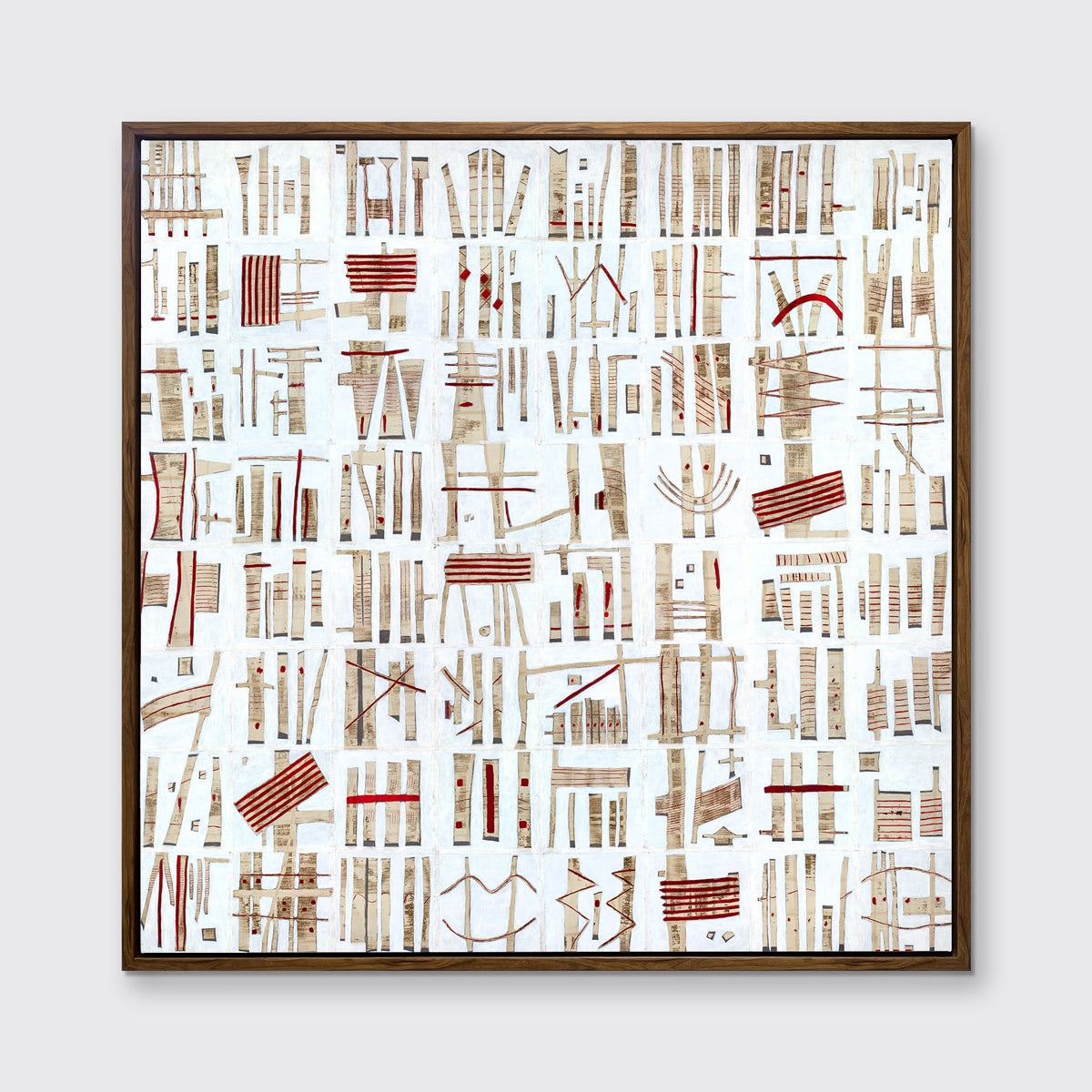 A white, beige and red abstract print in an oak wood floater frame hangs on a white wall.