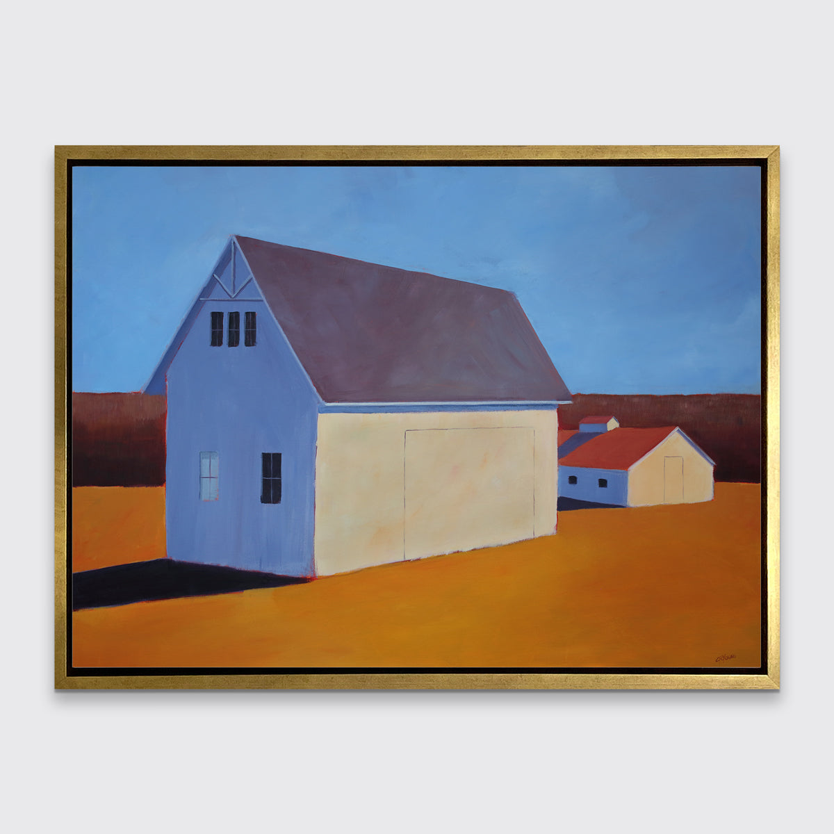A blue, dark orange, beige and lavender contemporary barn print in a gold floater frame hangs on a white wall.