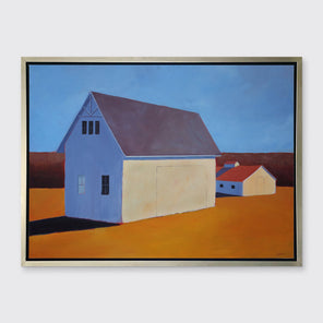 A blue, dark orange, beige and lavender contemporary barn print in a silver floater frame hangs on a white wall.