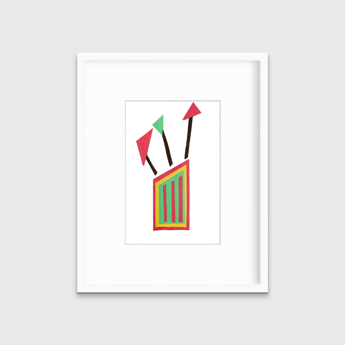 A red, yellow and black abstract collage print in a white frame with a mat hangs on a white wall.