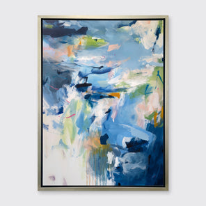 A blue, green and white abstract print by Kelly Rossetti in a silver floater frame hangs on a white wall.
