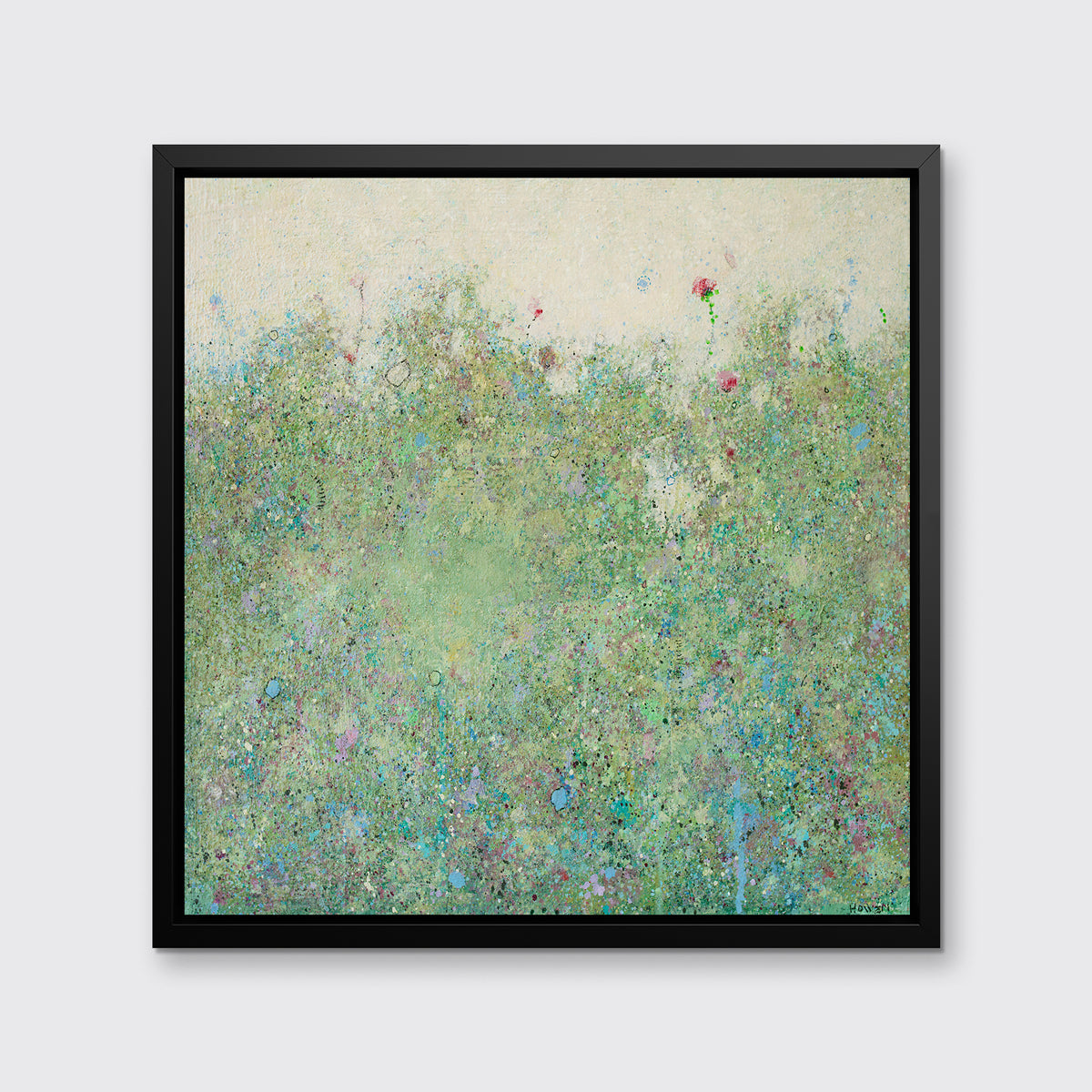 A green and light yellow abstract landscape print in a black floater frame hangs on a white wall.