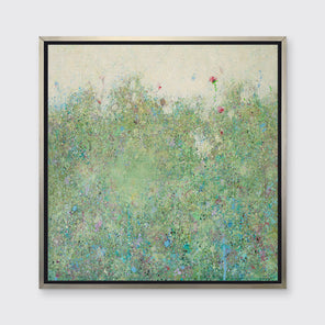 A green abstract landscape in a silver floater frame hangs on a white wall.