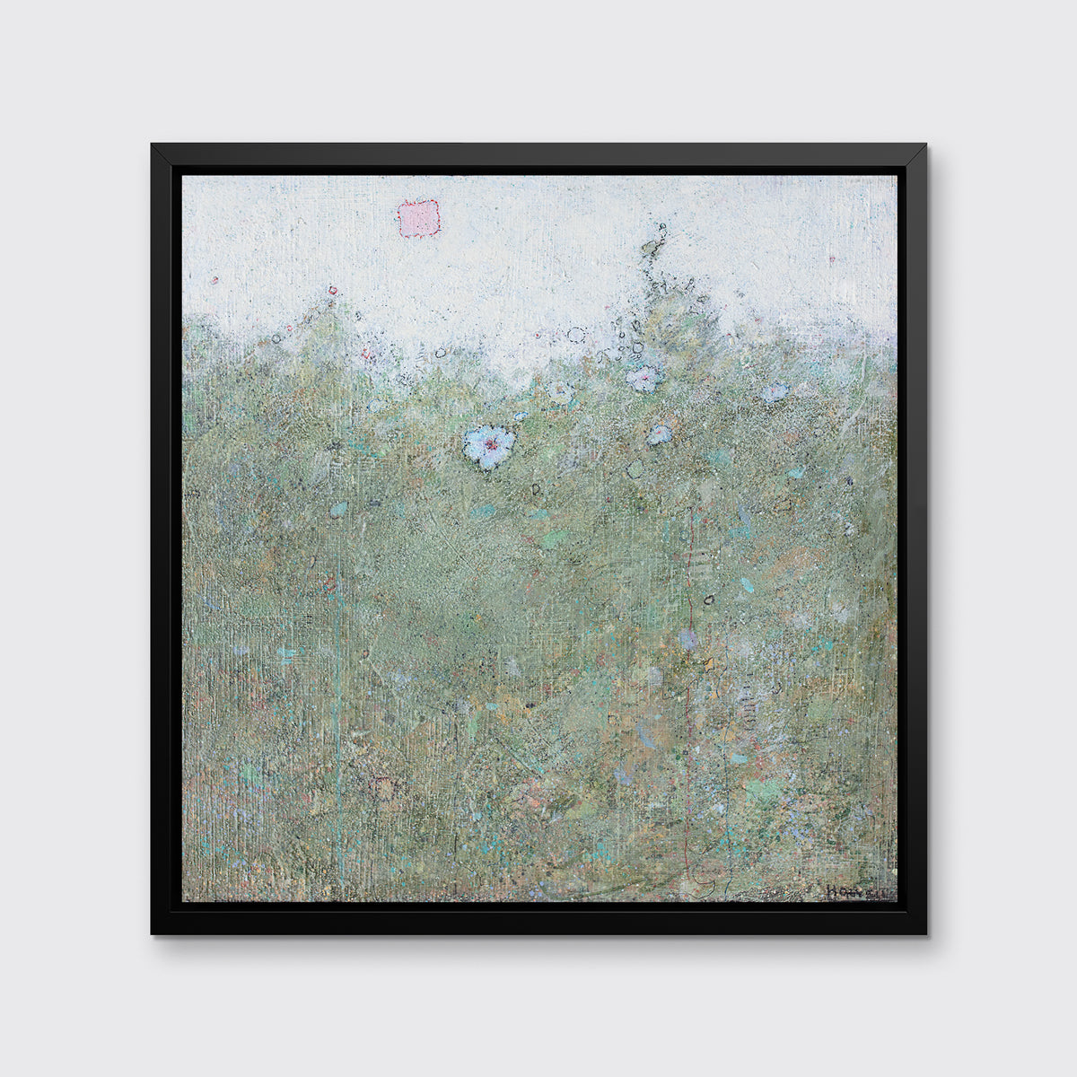 A blue and green abstract landscape print in a black floater frame hangs on a white wall.