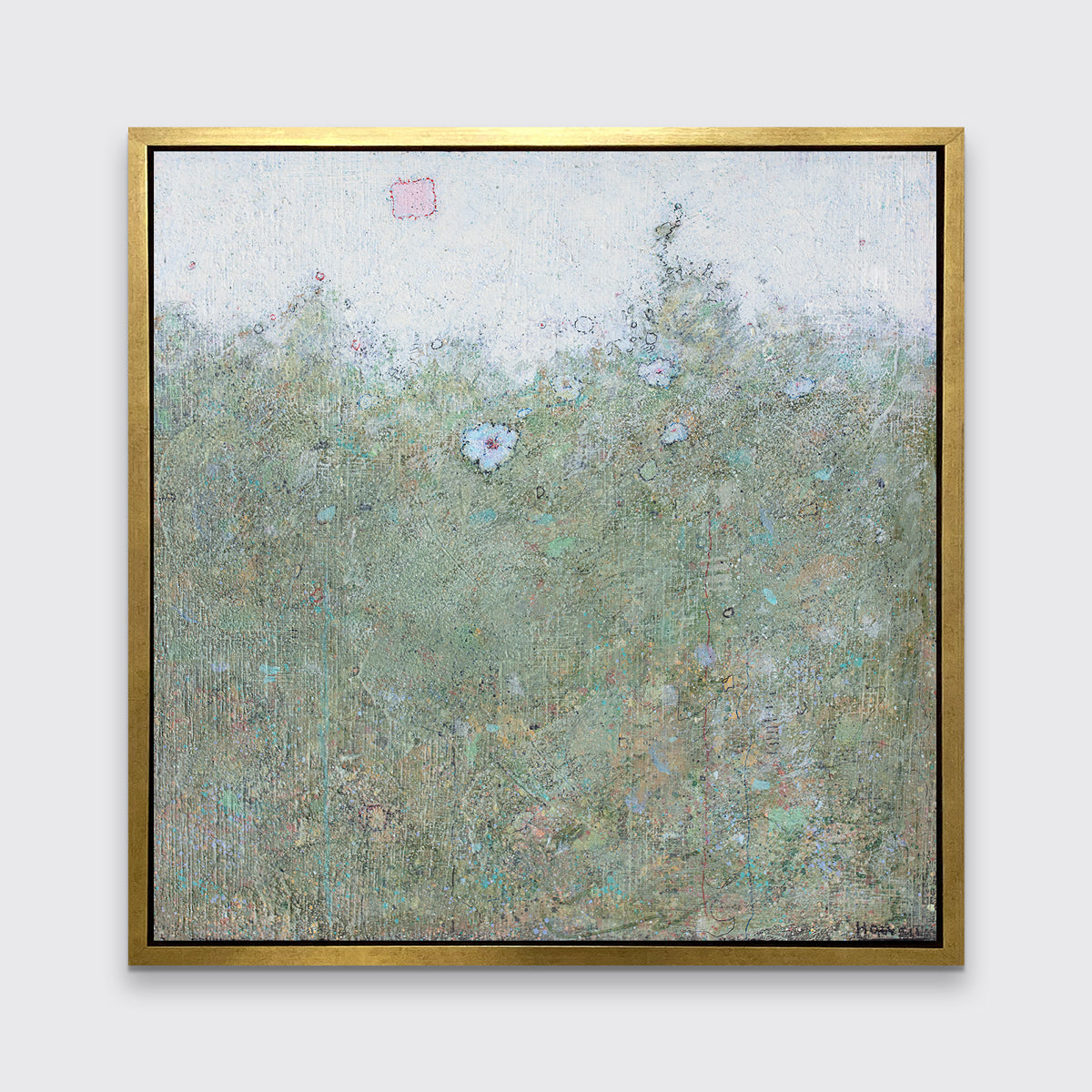 A blue and green abstract landscape print in a gold floater frame hangs on a white wall.