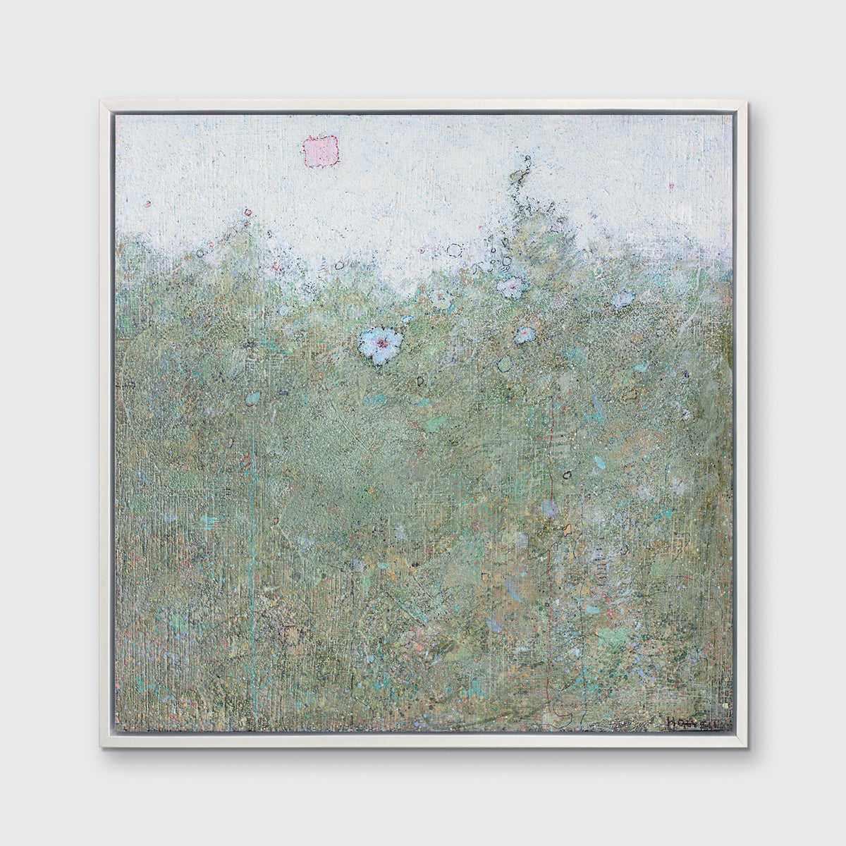 A green and blue abstract landscape print in a white floater frame hangs on a white wall.