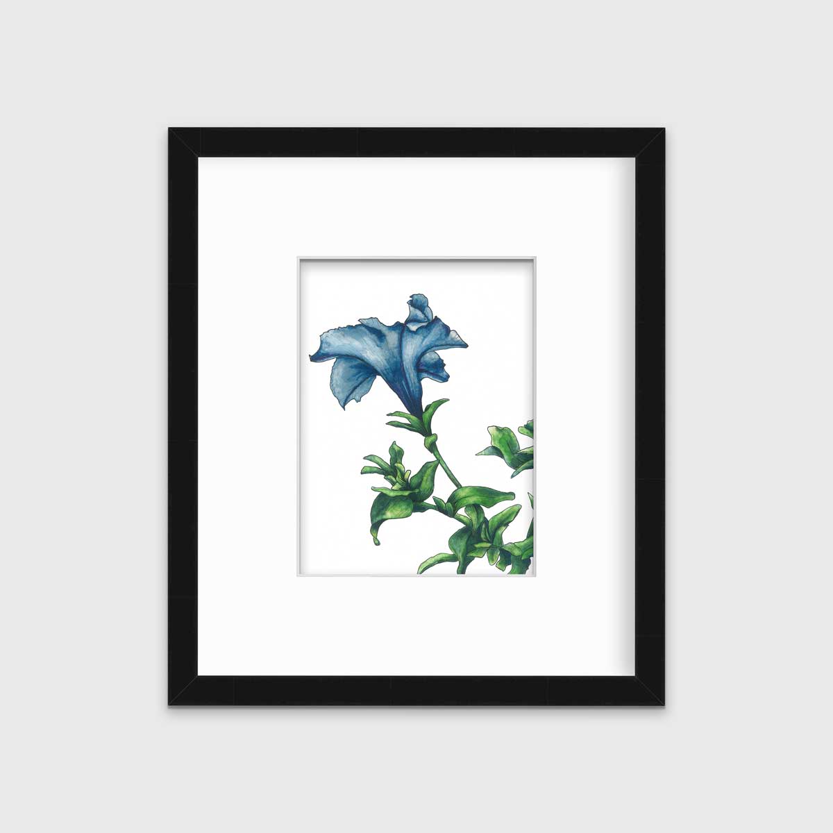 A blue and green flower print in a black frame with a mat hangs on a white wall.