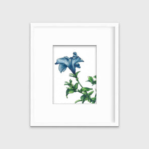 A blue and green flower print in a white frame with a mat hangs on a white wall.