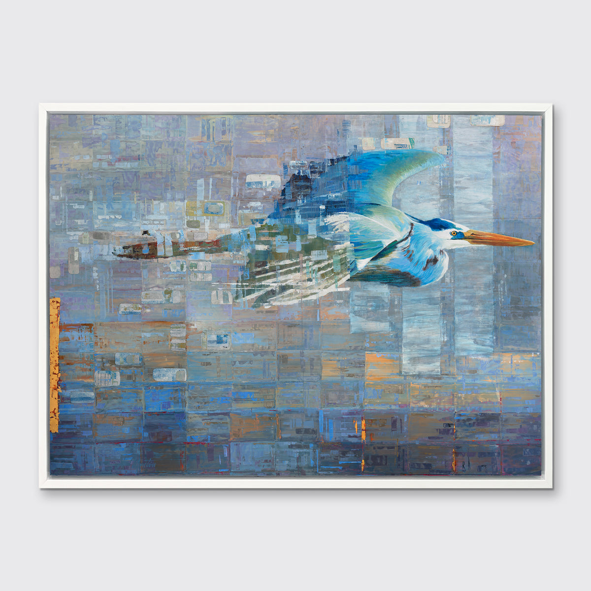 A blue, teal and light purple geometric abstract print of a blue heron in mid-flight with gold accents in a white floater frame hangs on a white wall.