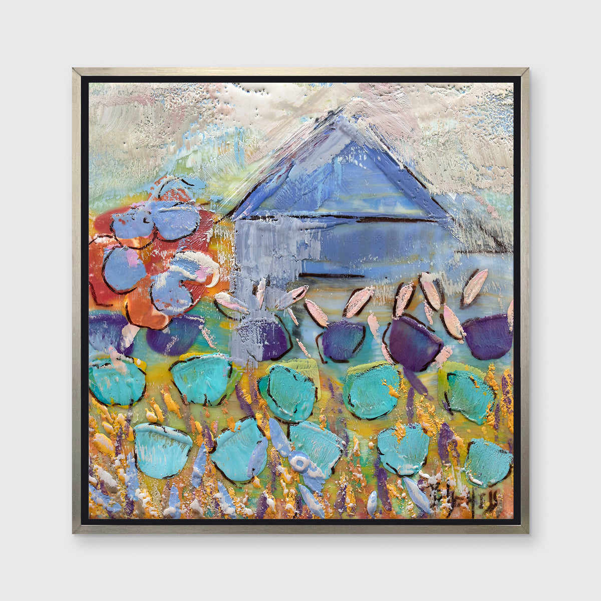 A multicolored abstract print in a silver floater frame hangs on a white wall.