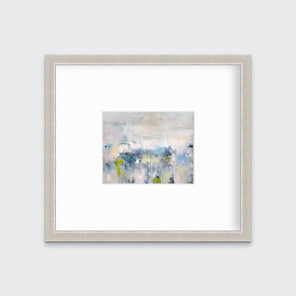 A pink and blue abstract print in a silver frame with a mat hangs on a white wall.