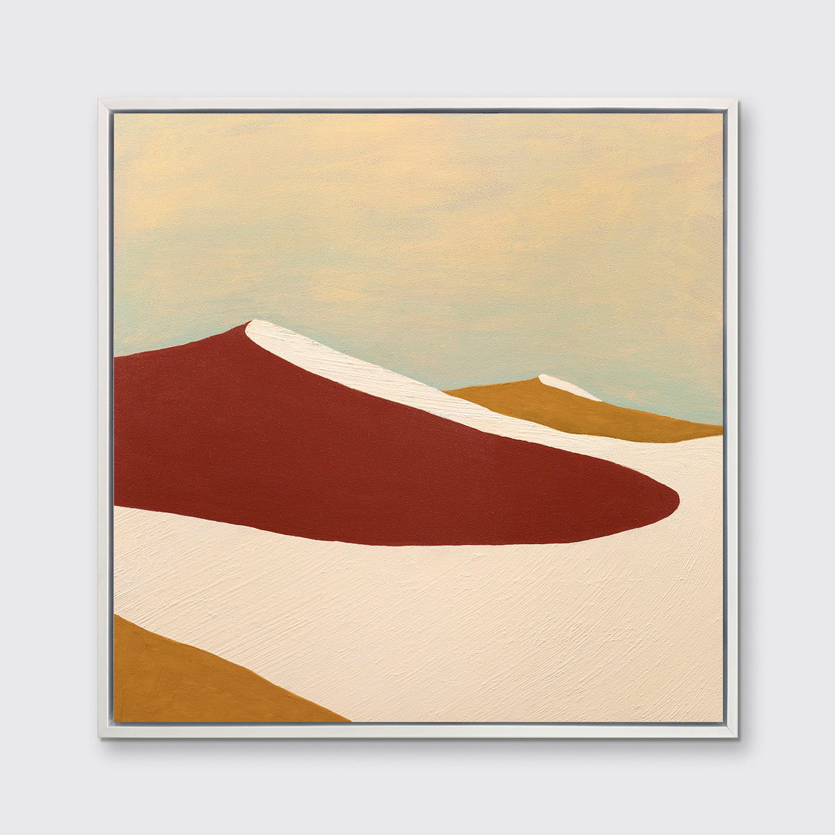 A red, burnt orange and beige abstract print in a white floater frame hangs on a white wall.