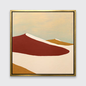 A red, burnt orange and beige abstract print in a gold floater frame hangs on a white wall.