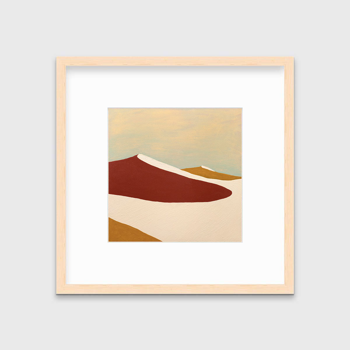 A red, burnt orange and beige abstract print in a natural wood frame with a mat hangs on a white wall.