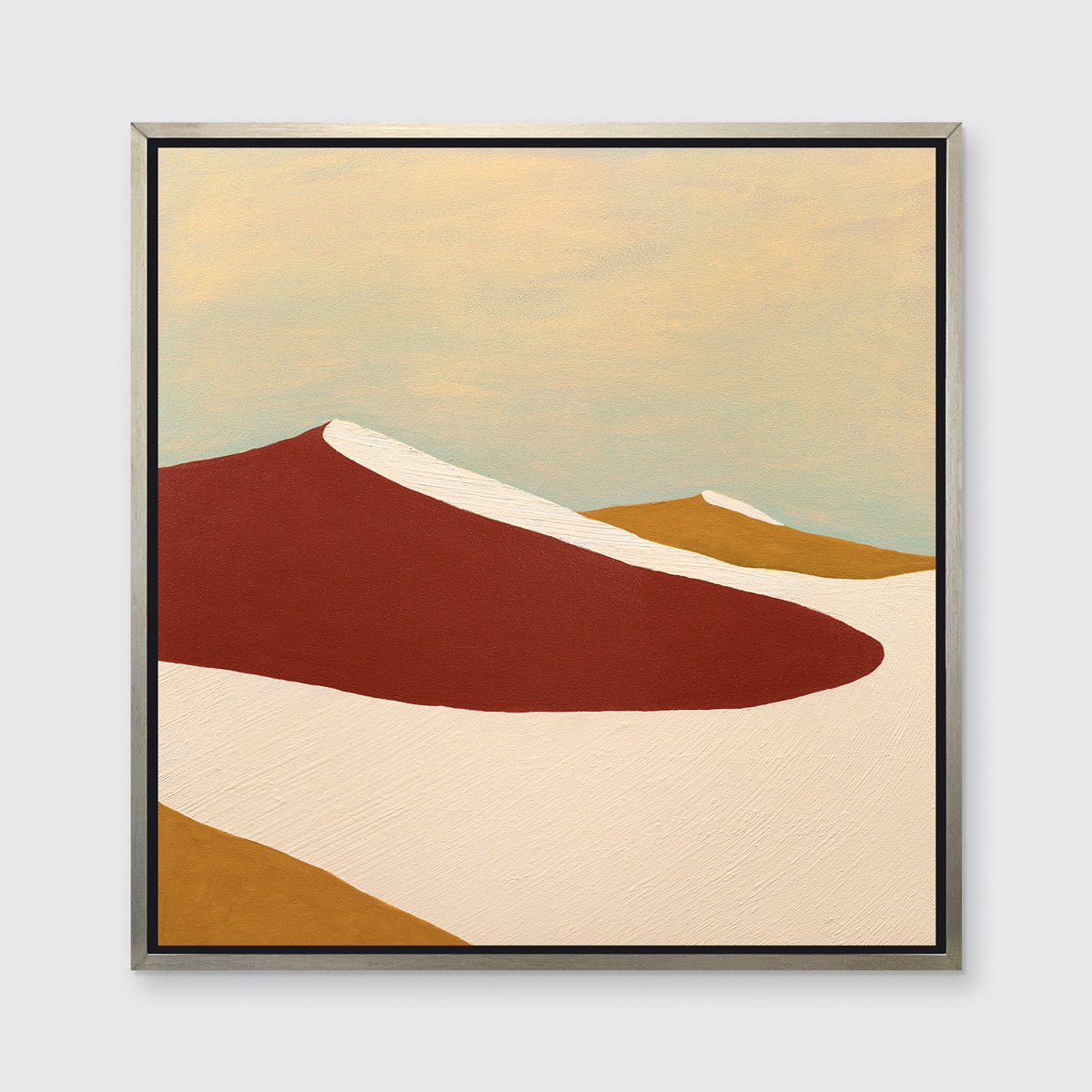 A red, burnt orange and beige abstract print in a silver floater frame hangs on a white wall.