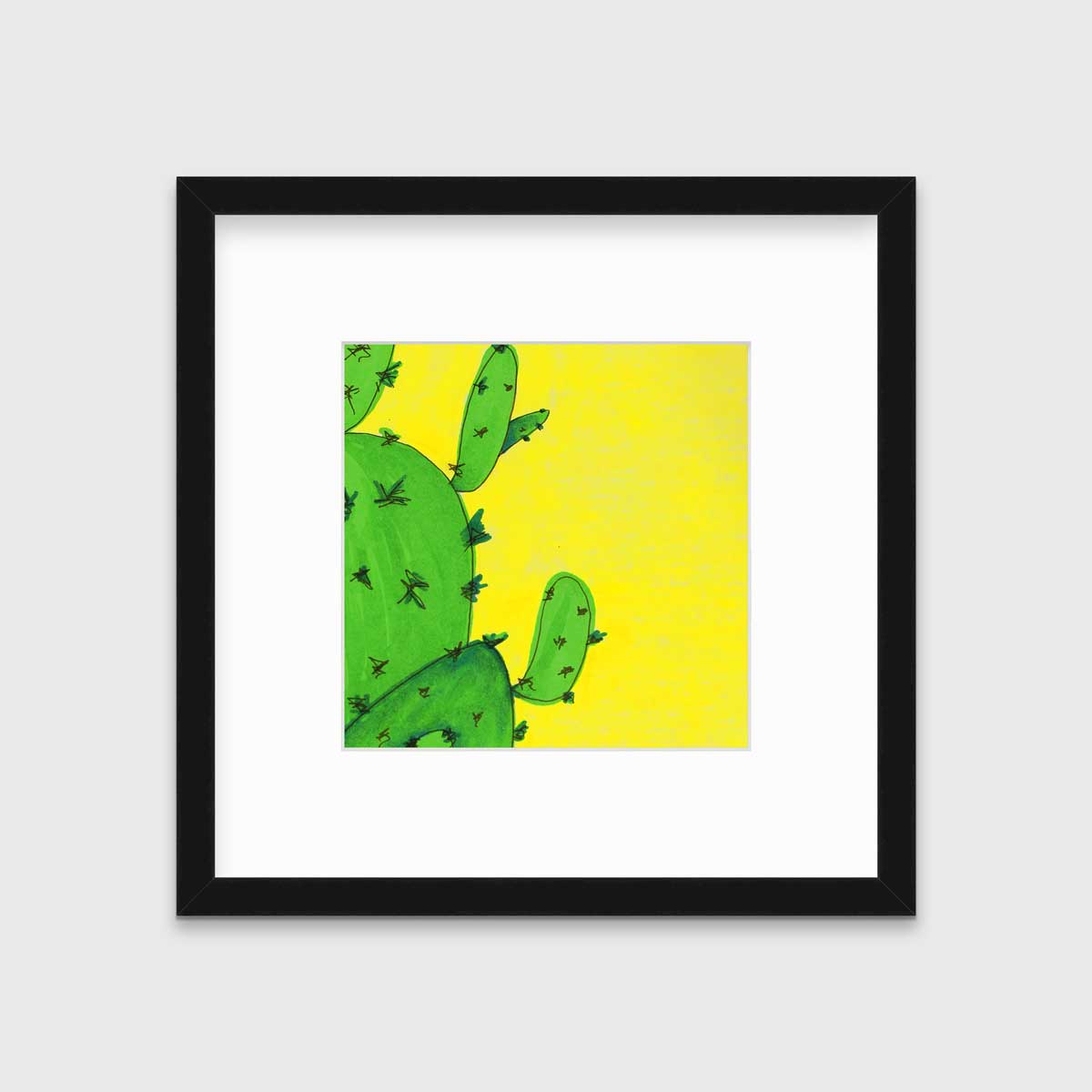 A print of a lime green cactus in front of a vibrant yellow background in a black frame with a mat hangs on a white wall.